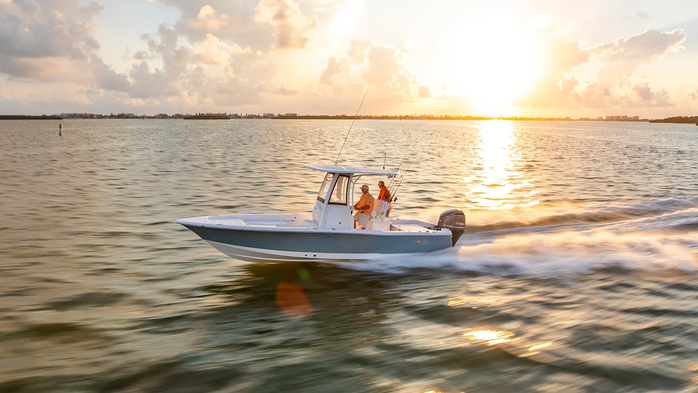Sea Hunt center console boat cruising at sunset